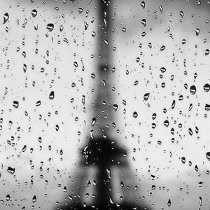 Eiffel tower through rainy window